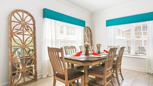 A dining room with a wooden table set for six, surrounded by six chairs. - Last Minute Disney Getaway! Private Pool & Themed Bedrooms. Book Now! #110749 (Orlando)