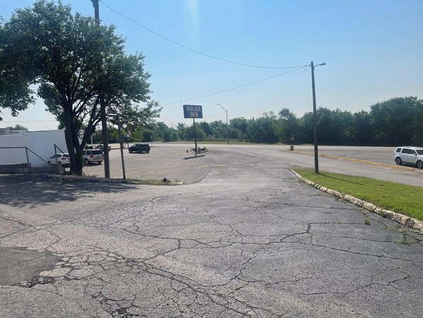 A parking lot with a sign for 'Relax Inn' in the distance.