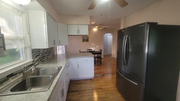 A kitchen with a refrigerator, double sink, and wooden flooring. - Do Not Book, VRBO sucks and won't let me delete this house I do not own anymore! (New Albany)