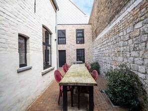 Enjoy dining in the charming courtyard surrounded by historic buildings.