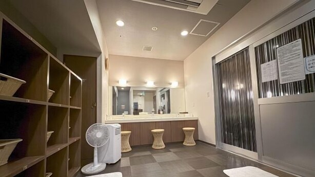 A hotel bathroom with a vanity, mirror, and shelves. - Hotel Route-Inn Hakata Ekimae -Hakataguchi- (Fukuoka)