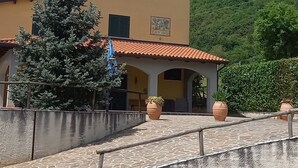 A building with a tiled roof and a stone-paved courtyard.
