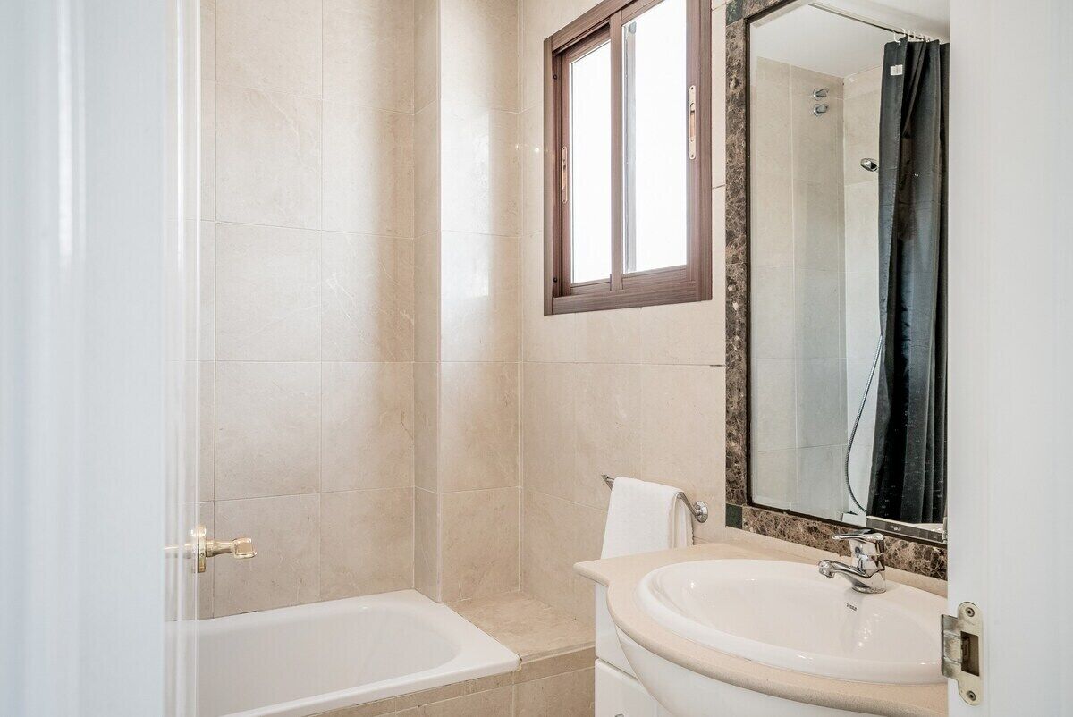A bathroom with a bathtub, a sink, and a shower.