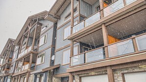 A multi-story building with balconies and large windows. - Snowy Creek by Okanagan Premier (Beaverdell)