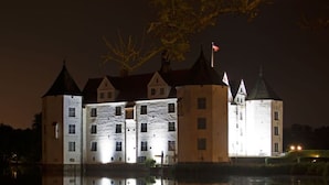 A castle with multiple towers and a moat. - Northern Lights Modern Retreat (Steinberg)