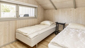 A compact room with two beds, a window, and wooden walls. - 4 Star Holiday Home in Praesto (Praesto)