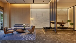 A modern interior with a sectional sofa, a round coffee table, and a small side table.