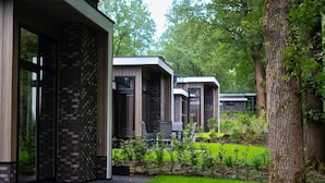A modern building with a brick facade and large windows. - Elegant Country Chalet in Guelders (Hoenderloo)