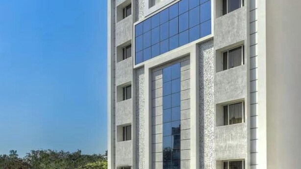 A modern building with large windows and a symmetrical facade. - Hotel Southern Grand (Vijayawada)