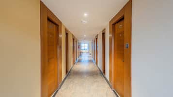 A long, narrow hallway with wooden doors numbered 504 and 505, leading to rooms.