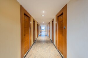 A long, narrow hallway with wooden doors numbered 504 and 505, leading to rooms.