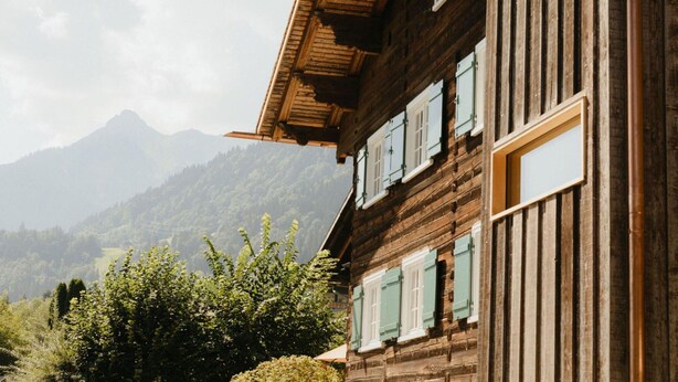 A wooden building with multiple windows and a sloped roof. - Chalet in Montafon With Private Sauna & Views (Vandans)