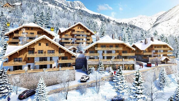 A multi-story lodge with wooden balconies and a stone facade, surrounded by snow-covered mountains. - Wifi, sauna, hammam, terrace, balcony, parking, ski locker, 41-43m², Vaujany (Vaujany)
