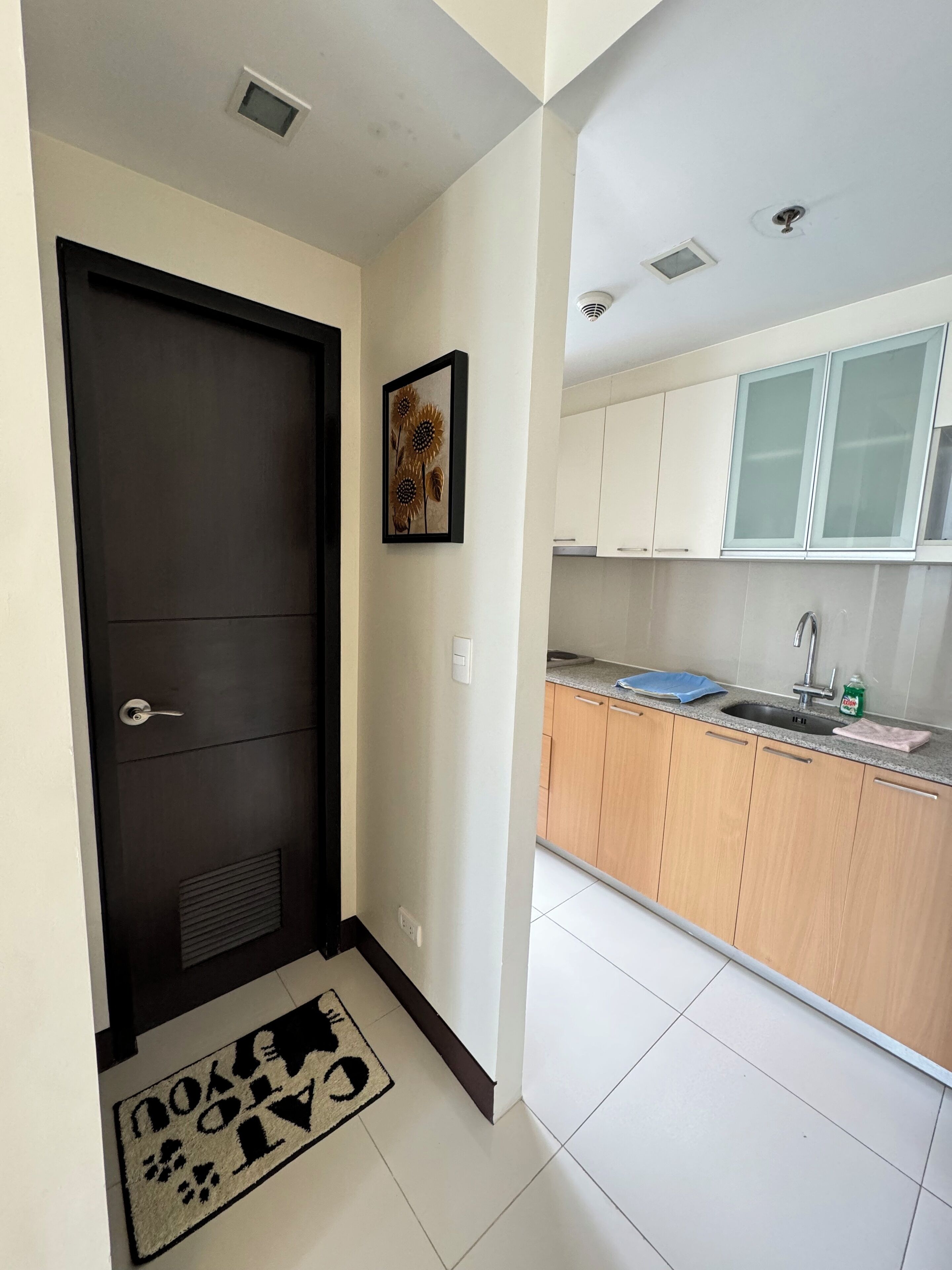 A modern kitchen with white cabinets, a sink, and a countertop.