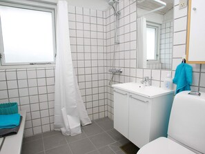 A bathroom with a shower, sink, and toilet. - 6 Person Holiday Home on a Holiday Park in Hanstholm (Hanstholm)