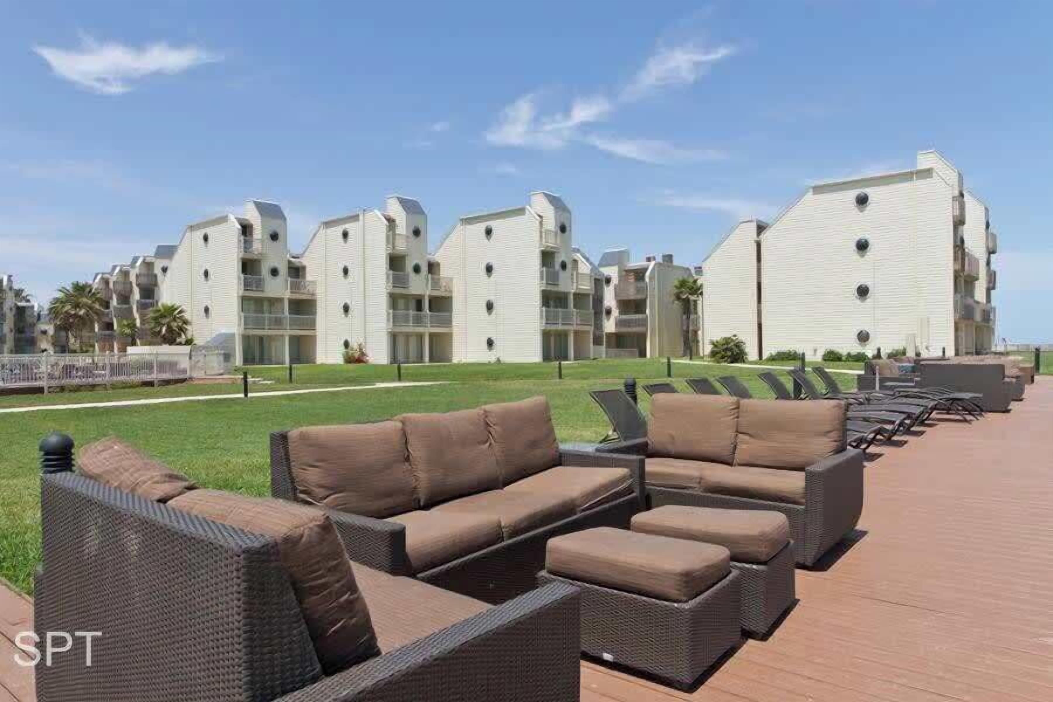 A resort with outdoor seating areas and modern buildings.