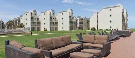 A resort with outdoor seating areas and modern buildings.