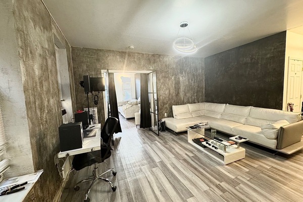 Living room area with beautiful glass doors that lead into one of the rooms.