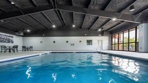 A swimming pool with a ceiling featuring exposed beams and recessed lighting. - Cityside Escape (Branson)