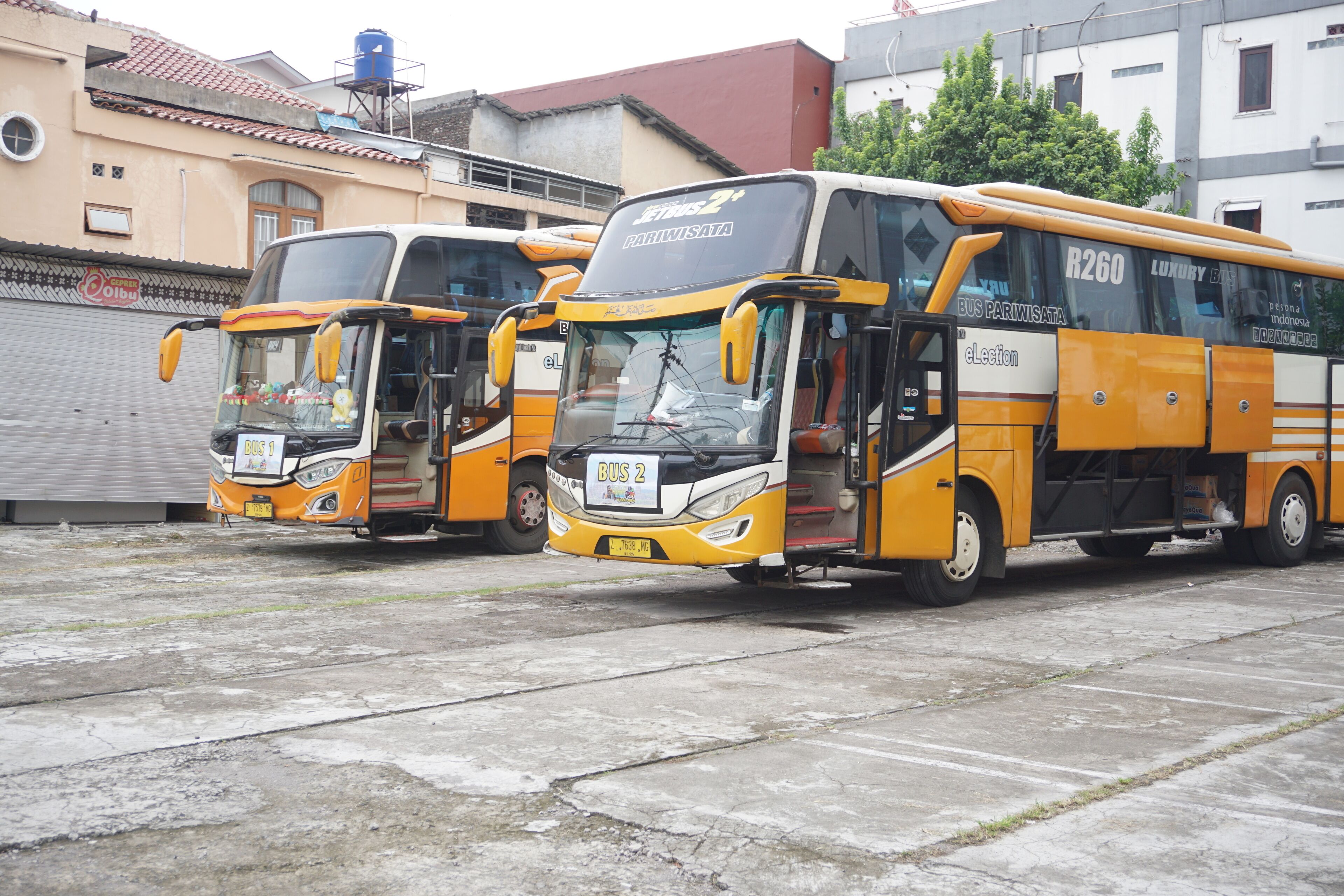 Three buses parked in a row.