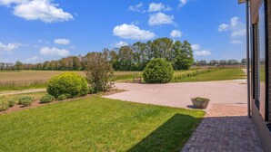 A paved driveway leading to a building with a brick facade. - Cozy Holiday Home in Oploo Near Forest (Oploo)