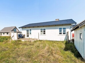 A single-story house with a dark roof, a front door, and a small porch area. - 4 Person Holiday Home in Frostrup (Frøstrup)