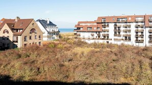 A coastal residential area with modern apartment buildings, featuring balconies and a view of the sea. - Apartment in Oostduinkerke Near the Beach (Koksijde)