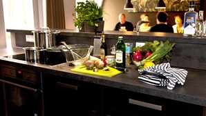 A modern kitchen with a granite countertop, stainless steel appliances, and a variety of fresh produce and cooking ingredients. - Spacious Retreat, Vlagtwedde (Vlagtwedde)
