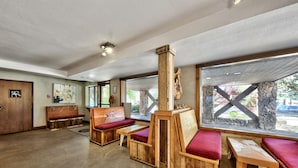 A rustic interior with wooden benches and a stone wall. - Holiday Inn Express South Lake Tahoe by IHG (South Lake Tahoe)