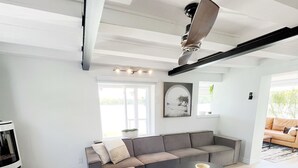 A modern living room with a sectional sofa, a round coffee table, and a fireplace. - Beautiful Private Lake Retreat - One of a kind! (Kawartha Lakes)