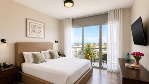 A hotel room with a bed, a desk, a TV, a window with a view, and a balcony. - Global Rent Apart (Hollywood)