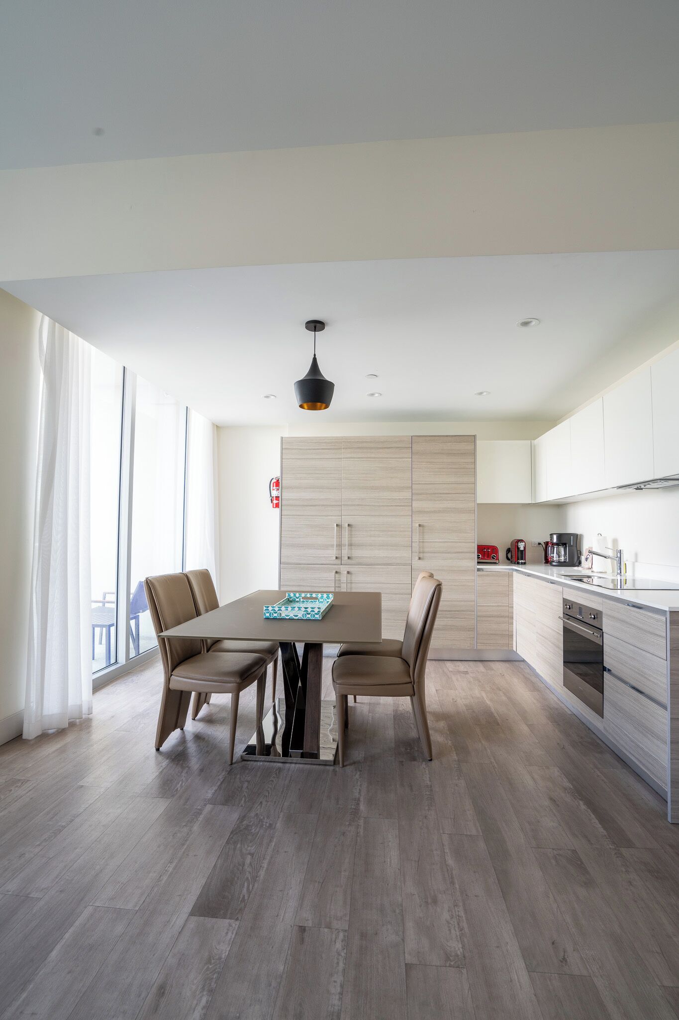 A modern kitchen with a dining area.