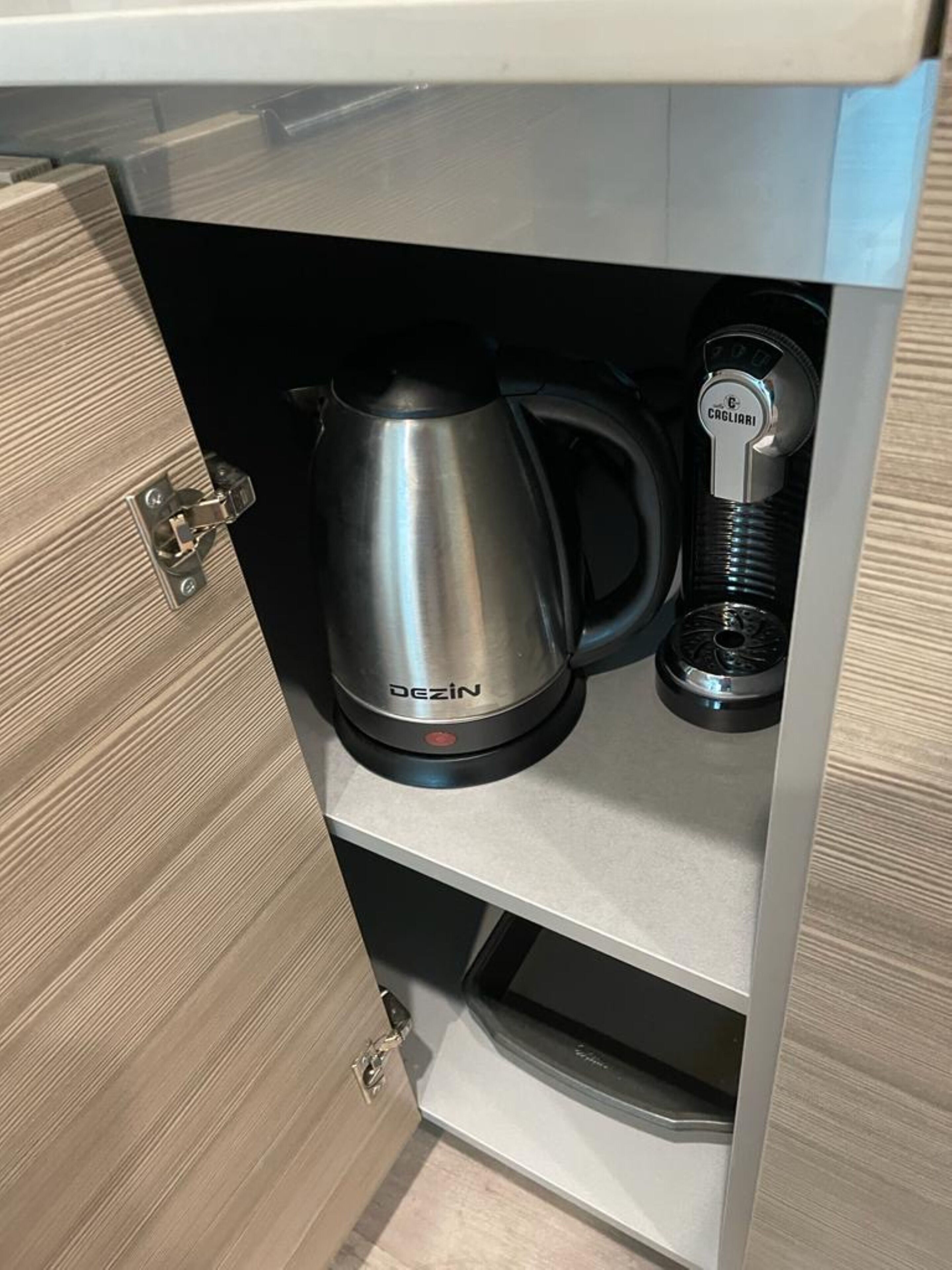 A kitchen with a Dezin coffee maker and a Cagliari espresso machine.