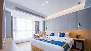 A modern hotel room with a large bed, a bedside table, a nightstand, and a small TV. - Super 8 Hotel Select (Guangzhou Station Xicun Metro Station) (Guangzhou)
