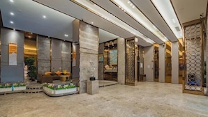 A spacious lobby with a marble floor, seating area with sofas, and a decorative wall with a geometric pattern. - Super 8 Hotel Select (Guangzhou Station Xicun Metro Station) (Guangzhou)