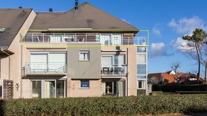 A multi-story residential building with a flat roof, balconies, and a gated entrance. - Maeterlinck 201 Sunny Penthouse in Koksijde (Koksijde)