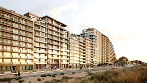 A modern hotel with multiple floors, balconies, and a beachside location. - Seaside Comfort With Parking (Nieuwpoort)