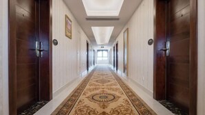 A long, narrow hallway with wooden doors on either side and a patterned carpet. - Vienna Classic Hotel (Shanghai Tinglin) (Shanghai)