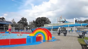 A water park with a pool, slides, and a rainbow play structure. - Holiday Home Zeeland Near Westerschelde (Baarland)
