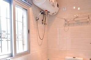 A bathroom with a window, a shower, and a towel rack. - Nanjing Sister Inn (Nanjing County)