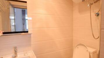 A bathroom with a sink, toilet, and shower.