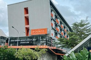 A modern building with a prominent orange sign reading 'BOUNTY HOTEL'.