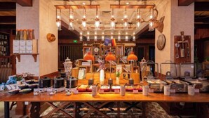 A buffet setup with various food items and a clock on the wall. - Shunhe Tianxi Hotel (Jinan Station, Jinan Maternal & Child Health Hospital) (Jinan)