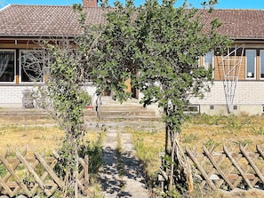 A pathway leading to a house with a tiled roof and brick walls. - 4 Person Holiday Home in Solvesborg (Sölvesborg)