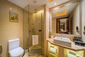 A modern bathroom with a glass shower enclosure, a white toilet, and a vanity with a large mirror. - Fengquan Hotel Changsha (Changsha)