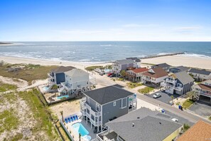 A coastal residential area with houses, a beach, and a clear view of the ocean. - Beach Access (Ocean Isle Beach)