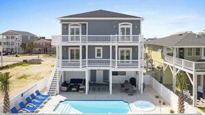 A two-story building with a balcony, a pool, and outdoor seating. - Beach Access (Ocean Isle Beach)