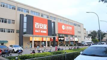 A commercial building with signage for B&T Home and a large sign for a local business.