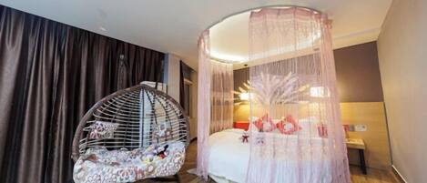 A room with a bed, a hanging chair, and a canopy bed.