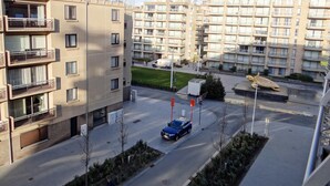 A multi-story residential building with balconies and a parking area. - Apartment in Nieuwpoort Near the Beach (Nieuwpoort)